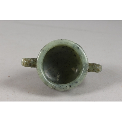 417 - A FINE CHINESE CARVED JADE TWIN HANDLE CENSER, with archaic designs, applied collection sticker to b... 