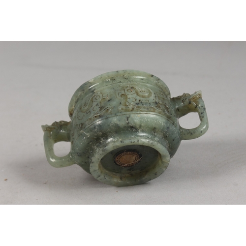 417 - A FINE CHINESE CARVED JADE TWIN HANDLE CENSER, with archaic designs, applied collection sticker to b... 