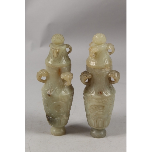 418 - A PAIR OF CHINESE CARVED JADE LIDDED VASES, each with three ring handles to the neck and carved with... 