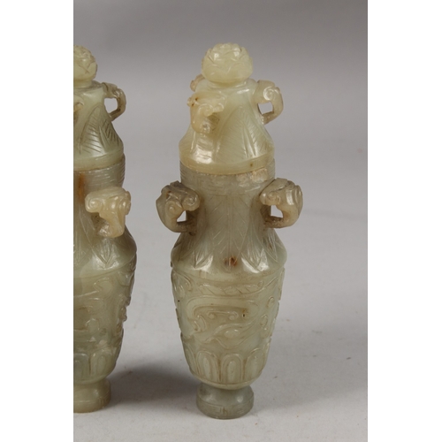 418 - A PAIR OF CHINESE CARVED JADE LIDDED VASES, each with three ring handles to the neck and carved with... 