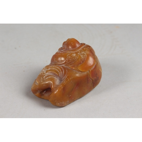 419 - A CHINESE AMBER-COLOUR SOAPSTONE CARVING OF LUOHAN, 6cm wide.