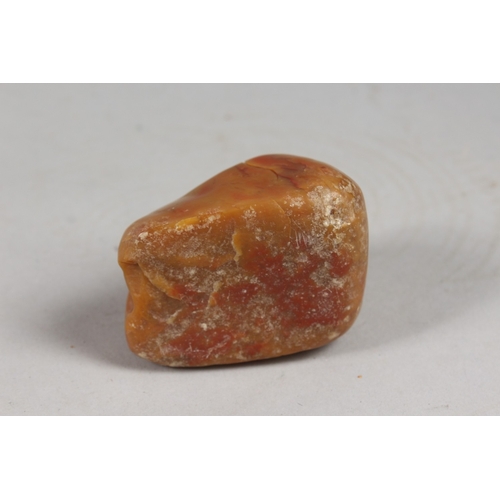 419 - A CHINESE AMBER-COLOUR SOAPSTONE CARVING OF LUOHAN, 6cm wide.