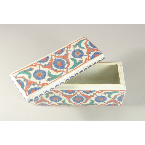 441 - A TURKISH IZNIK GLAZED POTTERY RECTANGLAR LIDDED BOX, 28cm long.