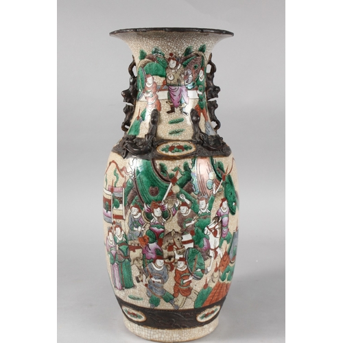 6 - A 19TH CENTURY CHINESE CRACKLE GLAZE PORCELAIN VASE, painted with warriors, the neck with moulded ha... 