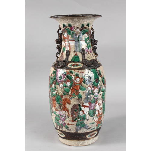 6 - A 19TH CENTURY CHINESE CRACKLE GLAZE PORCELAIN VASE, painted with warriors, the neck with moulded ha... 