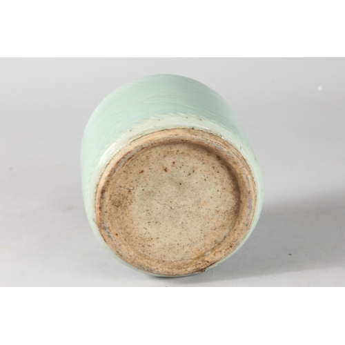 8 - AN EARLY CHINESE CELADON GLAZE POTTERY BRUSH POT, 10.5cm high.