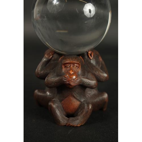 86 - A VERY FINE JAPANESE CARVED WOOD OKIMONO OF THREE WISE MONKEYS WITH GLASS BALL, in the manner of Mas... 