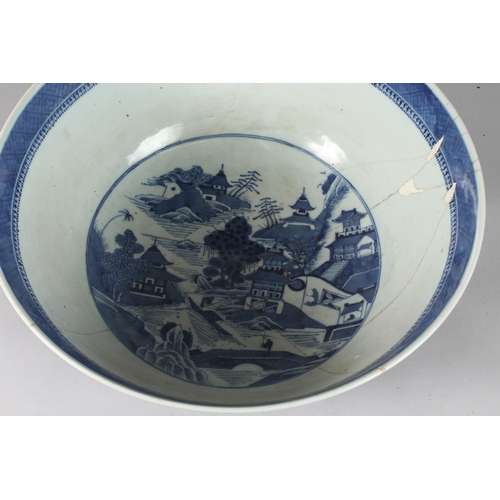 92 - A VERY LARGE CHINESE BLUE AND WHITE PORCELAIN PUNCH BOWL, decorated with buildings in a landscape sc... 