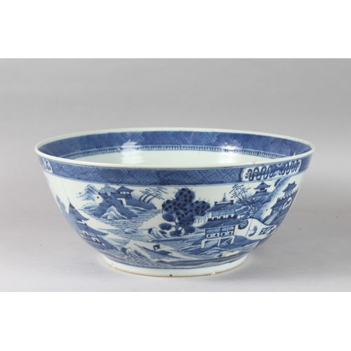 92 - A VERY LARGE CHINESE BLUE AND WHITE PORCELAIN PUNCH BOWL, decorated with buildings in a landscape sc... 