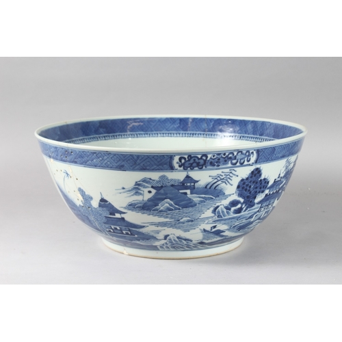 92 - A VERY LARGE CHINESE BLUE AND WHITE PORCELAIN PUNCH BOWL, decorated with buildings in a landscape sc... 