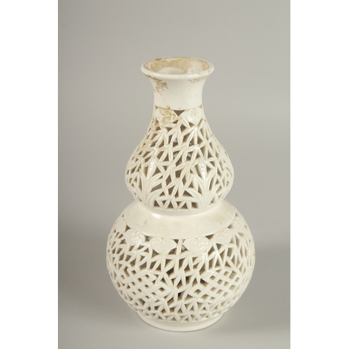 97 - A CHINESE PIERCED PORCELAIN DOUBLE GOURD VASE, 20.5cm high.