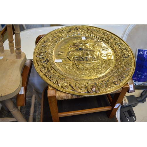 108 - Embossed brass charger and a stool.