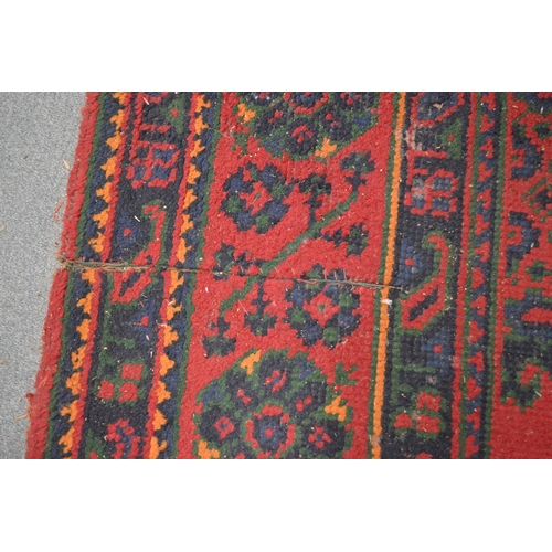 283 - A large Turkish carpet, red ground with stylised decoration (cut and repaired), 380cm x 250cm.