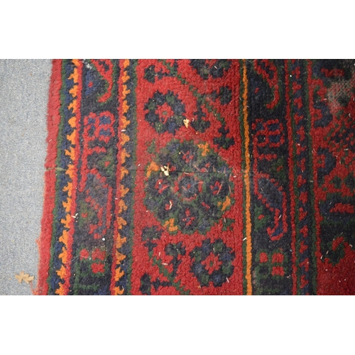 283 - A large Turkish carpet, red ground with stylised decoration (cut and repaired), 380cm x 250cm.