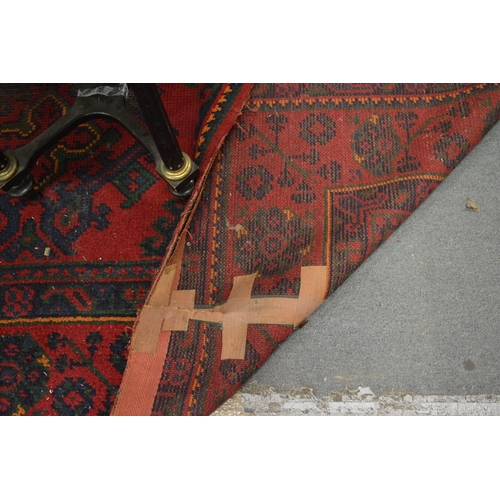 283 - A large Turkish carpet, red ground with stylised decoration (cut and repaired), 380cm x 250cm.