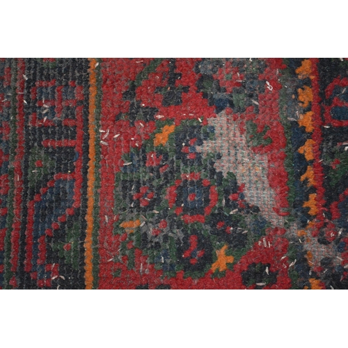 283 - A large Turkish carpet, red ground with stylised decoration (cut and repaired), 380cm x 250cm.