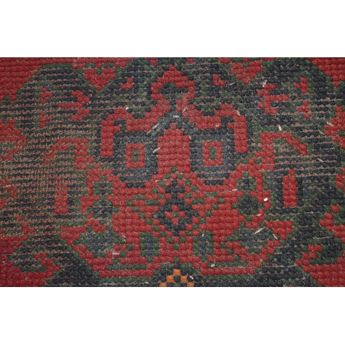 283 - A large Turkish carpet, red ground with stylised decoration (cut and repaired), 380cm x 250cm.