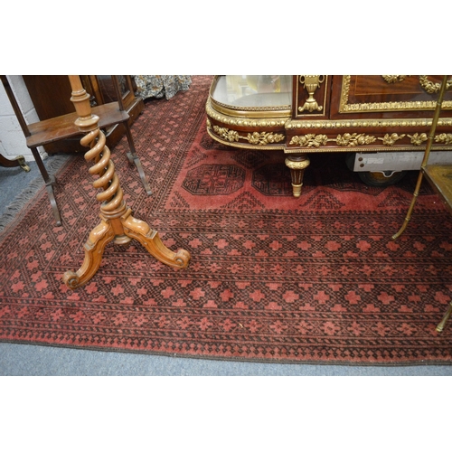 286 - A large Afghan carpet, rust ground with stylised decoration, 350cm x 250cm.