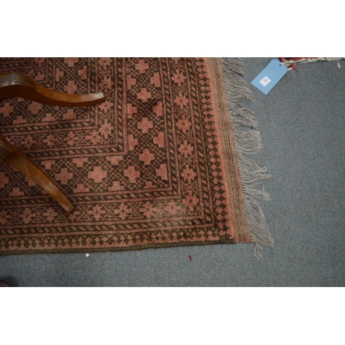 286 - A large Afghan carpet, rust ground with stylised decoration, 350cm x 250cm.