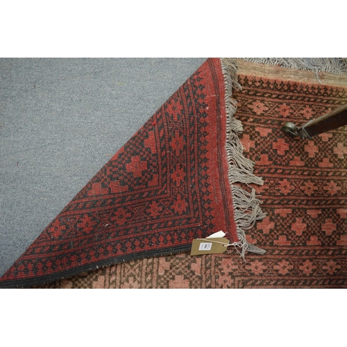 286 - A large Afghan carpet, rust ground with stylised decoration, 350cm x 250cm.