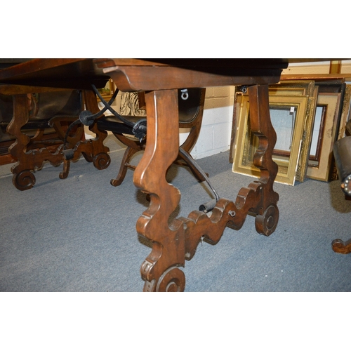 327 - A good Spanish baroque style walnut dining table with wrought iron stretchers.