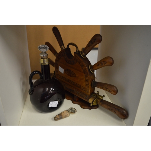 33 - A knife set with carving knife and fork contained in a carved wood stand together with an amber colo... 