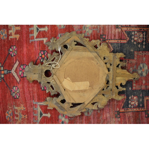 335 - A good early carved wood shield shaped mirror.