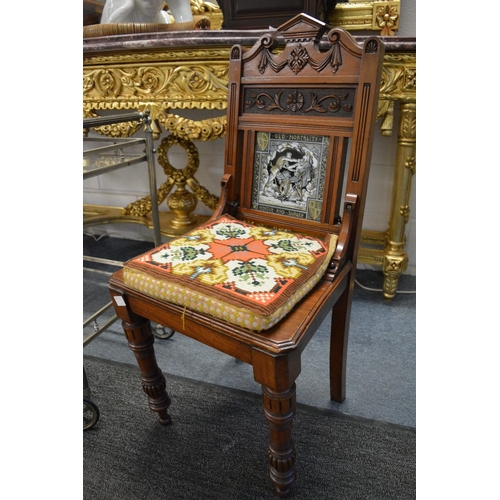 339 - A pair of Victorian walnut hall chairs, the carved panelled backs inset with allegorical porcelain t... 