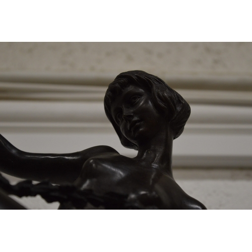 521 - An Art Nouveau style bronze of a female nude dancer on a circular marble base.