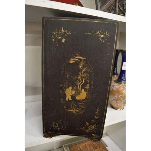 556 - A Japanese black lacquer and gilt decorated table cabinet.