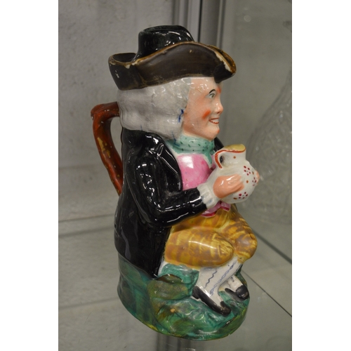 584 - An early toby jug with lid.