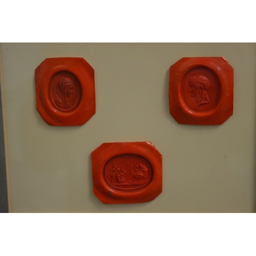 596 - Six wax seals housed in two framed and glazed cases.