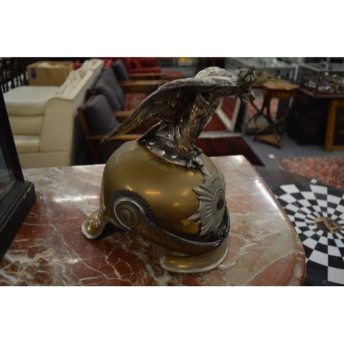 782 - A large Prussian brass and leather helmet with eagle mount.