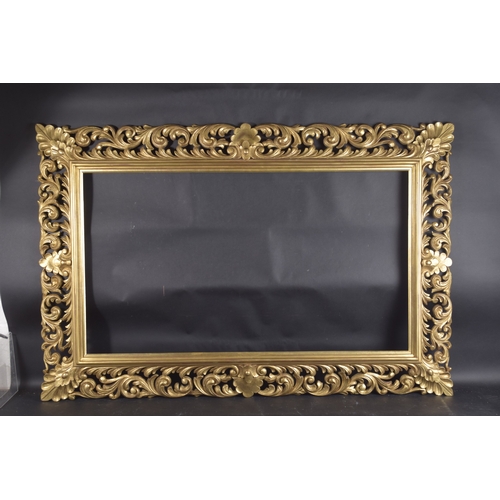 15 - A GOOD CARVED FLORENTINE GILTWOOD PICTURE FRAME. Rebate size 24inx x 42ins.