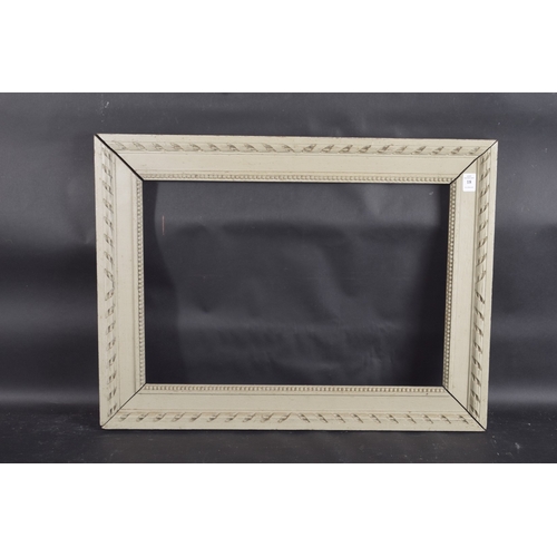 18 - A PALE WASH WOODEN PICTURE FRAME Rebate size 15ins x 21ins.