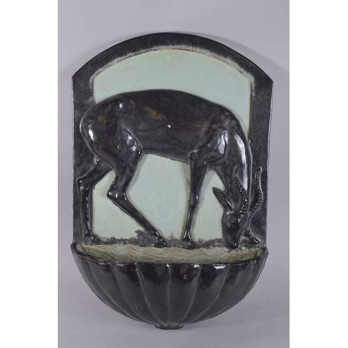 567 - AN ART DECO LARGE POTTERY WALL POCKET, modelled as a deer at a watering hole. 2ft 0ins high x 1ft 5i... 