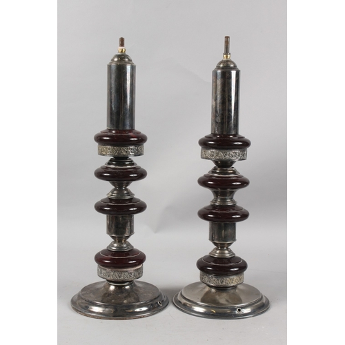 227 - A VERY FINE PAIR OF CIRCULAR PLATED TABLE LAMP BASES, the columns inserted with possibly bakelite di... 