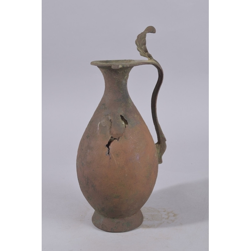 244 - A 9TH-10TH CENTURY ABBASID BRONZE EWER, with leaf-formed terminal to the top of handle, 34cm high.