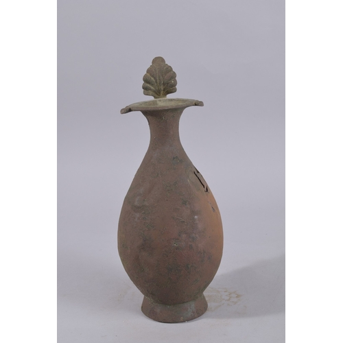 244 - A 9TH-10TH CENTURY ABBASID BRONZE EWER, with leaf-formed terminal to the top of handle, 34cm high.