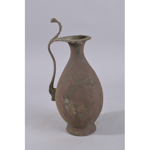 244 - A 9TH-10TH CENTURY ABBASID BRONZE EWER, with leaf-formed terminal to the top of handle, 34cm high.