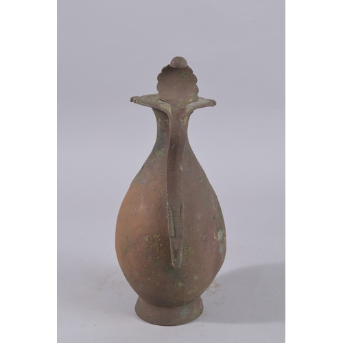 244 - A 9TH-10TH CENTURY ABBASID BRONZE EWER, with leaf-formed terminal to the top of handle, 34cm high.