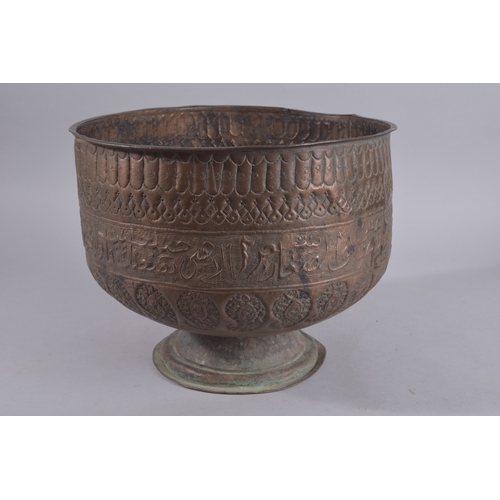 245 - A LARGE LATE QAJAR EMBOSSED AND CHASED FOOTED COPPER BOWL, with a band of calligraphy and paisley de... 