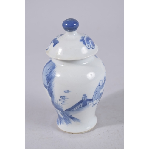 320 - A CHINESE BLUE AND WHITE PORCELAIN JAR AND COVER, painted with figures in a garden, 13cm high.