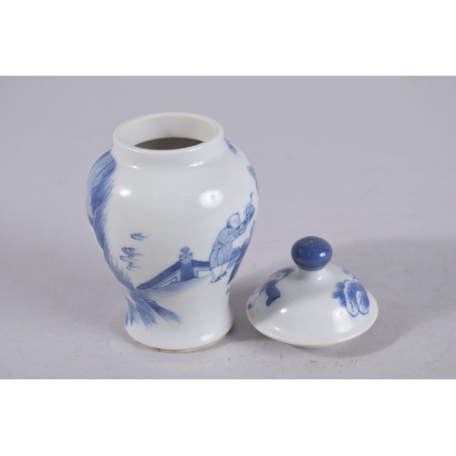 320 - A CHINESE BLUE AND WHITE PORCELAIN JAR AND COVER, painted with figures in a garden, 13cm high.