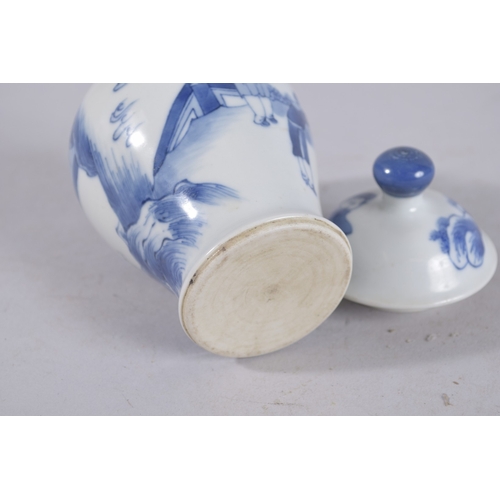 320 - A CHINESE BLUE AND WHITE PORCELAIN JAR AND COVER, painted with figures in a garden, 13cm high.