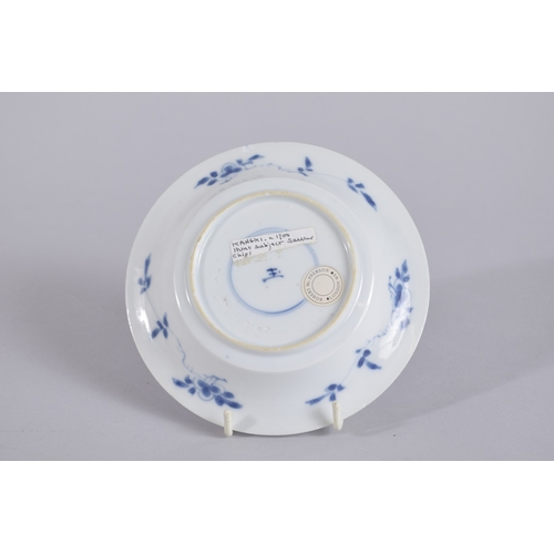 35 - A CHINESE KANGXI PERIOD BLUE AND WHITE PORCELAIN SAUCER, painted with a hunting scene, mark to base,... 