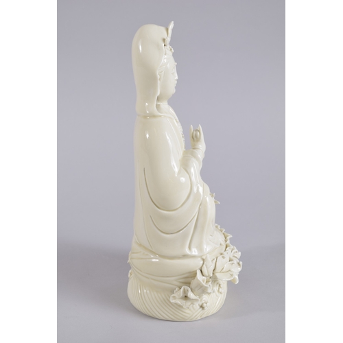 36 - AN EARLY 20TH CENTURY DEHUA PORCELAIN GUANYIN, with two impressed seal marks to the reverse, 27cm hi... 