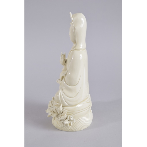 36 - AN EARLY 20TH CENTURY DEHUA PORCELAIN GUANYIN, with two impressed seal marks to the reverse, 27cm hi... 