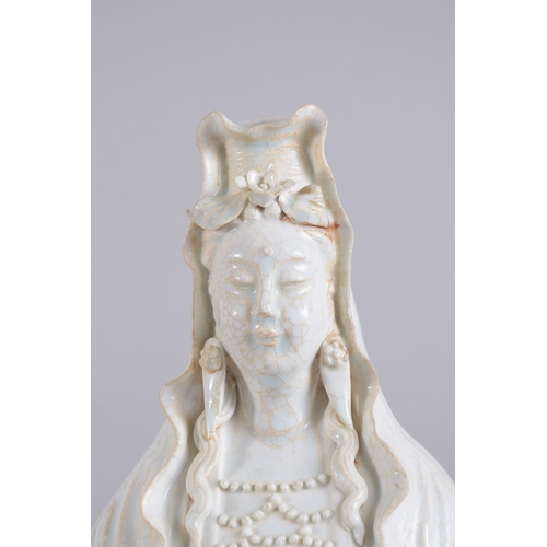 37 - A LARGE 20TH CENTURY CHINESE QINGBAI POTTERY GUANYIN, 51cm high.