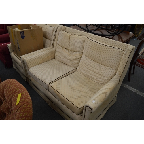 265 - A two seater settee and matching armchair, with a set of spare loose covers.